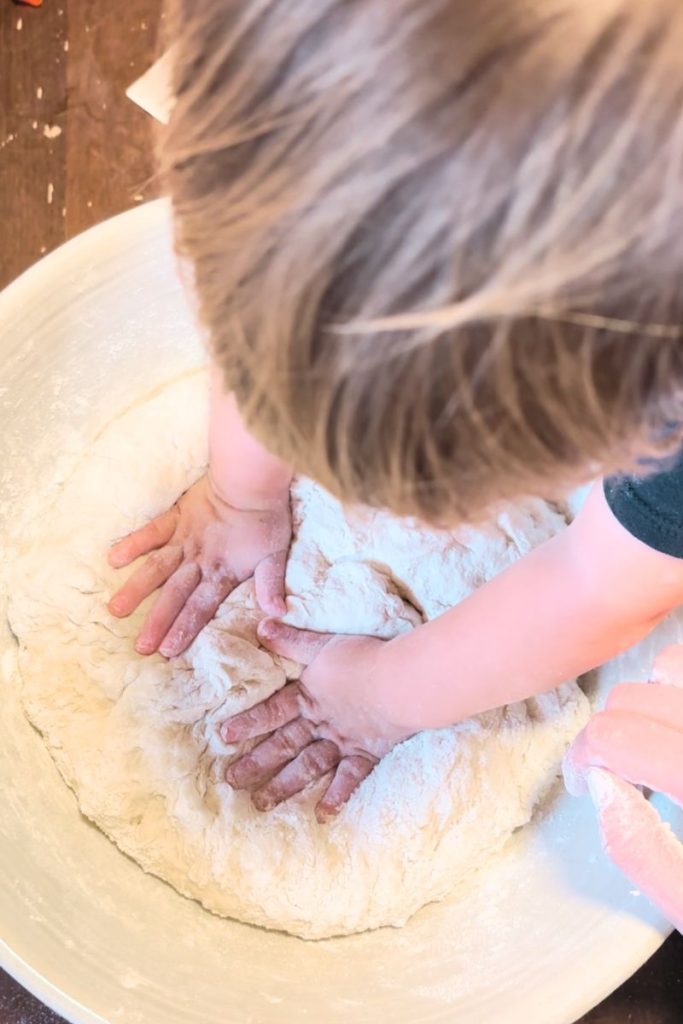 Toddler hands kneading dough